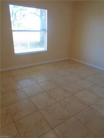 Guest bedroom 2 featuring light tile patterned floors