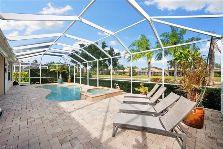 View of swimming pool featuring a lanai, a sunroom, a patio, and a pool with connected hot tub