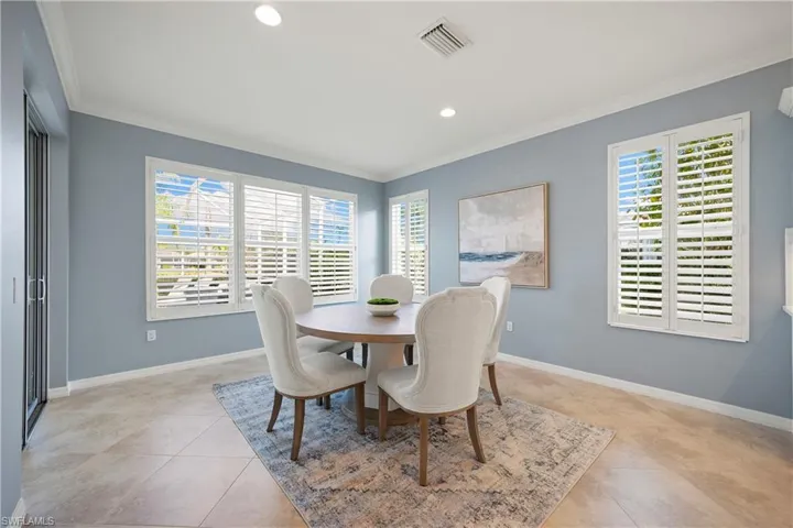 Dining space with recessed lighting, crown molding, and light tile patterned floors