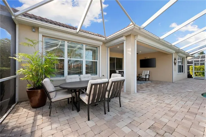 Sunroom / solarium featuring outdoor dining area and a patio area