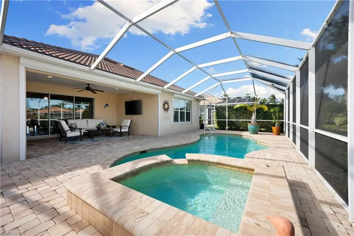 View of swimming pool featuring an outdoor living space, a sunroom, a patio area, and a lanai