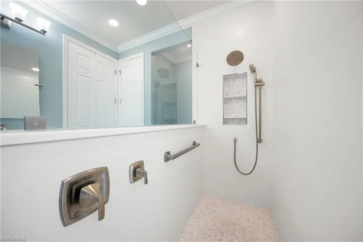 Full bathroom with a walk in shower, ornamental molding, and recessed lighting