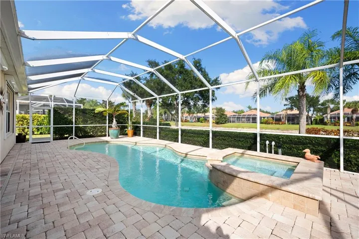 View of swimming pool featuring a lanai, a sunroom, a patio area, and a pool with connected hot tub