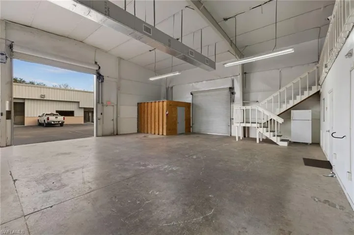 Garage featuring white refrigerator
