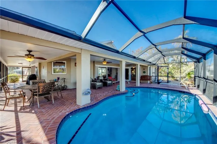Unique wrap around Lanai offers multiple choices for covered sitting areas all with views of the waterway and access to the lovely swimming pool. All of the sliding glass doors are impact rated and pocket back allowing a fantastic flow for entertaining and allowing for the wonderful River breezes. Views from the Pool area feature River and Sunset views.