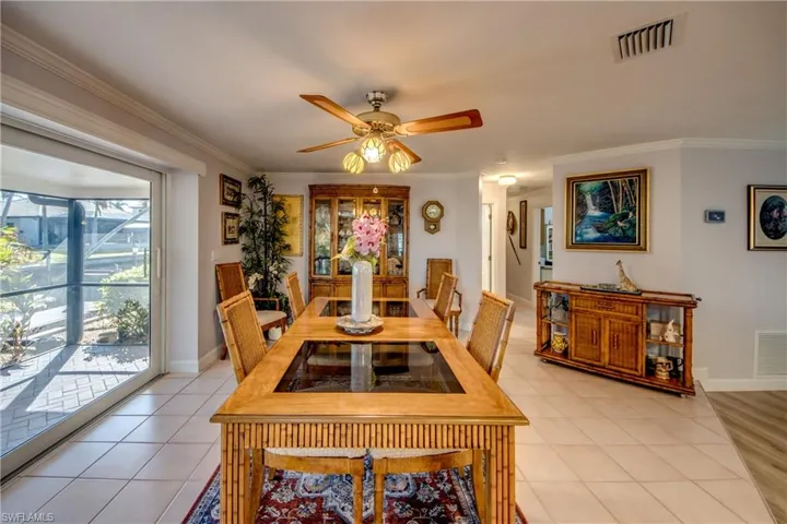 Large dining room opens to the wrap around Lanai through pocketing impact rated sliding glass doors. Features include gorgeous waterway views, tile flooring, crown molding and an open floor plan.