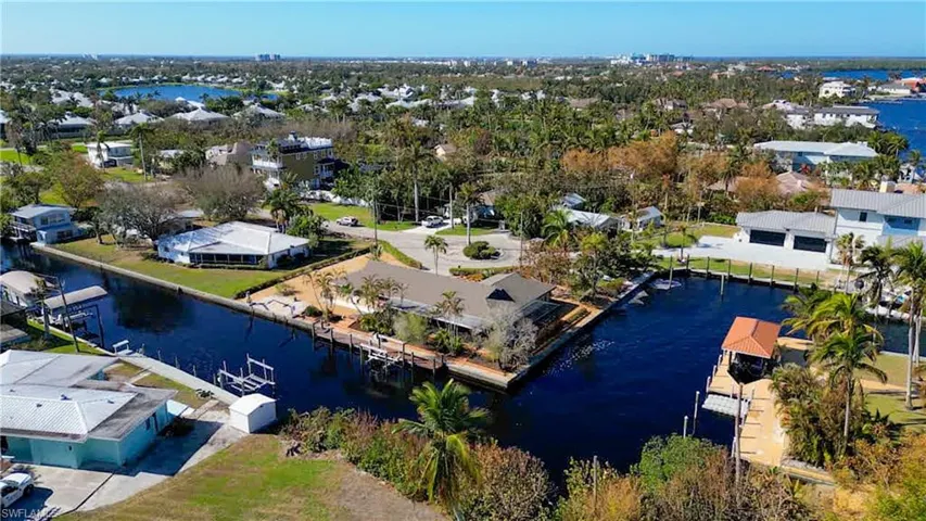 Delightful updated Pool home located on a quite cul-de-sac. Features approximately 239 Ft of water frontage just off the Caloosahatchee River. NO Bridges. Just minutes by boat to Sanibel, Back Bay or the Gulf of Mexico! Features Dock with 10 lb boat lift and davits for your smaller boat or jet skis. Meticulously maintained and upgraded. Wrap around Lanai with water views and sunset views from the Pool deck & Lanai!