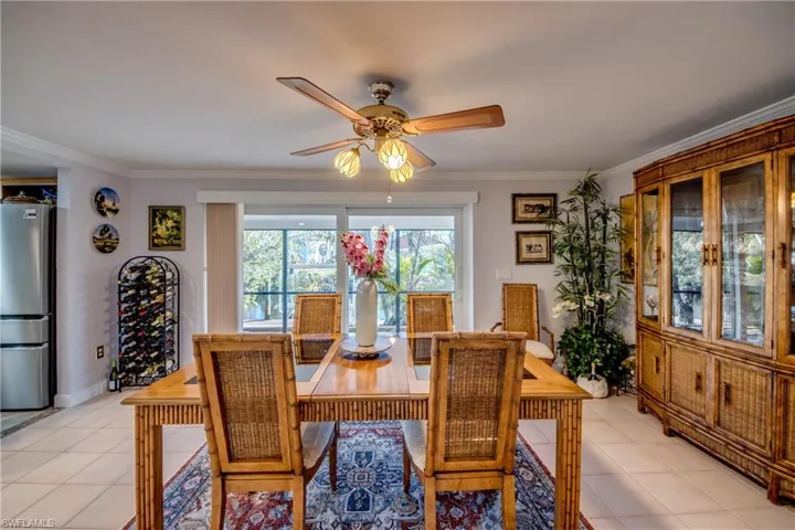Large dining room opens to the wrap around Lanai through pocketing impact rated sliding glass doors. Features include gorgeous waterway views, tile flooring, crown molding and an open floor plan.