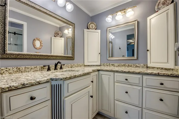 New master en-suite bathroom with custom cabinetry, granite counters, new tile flooring and elegant new shower.