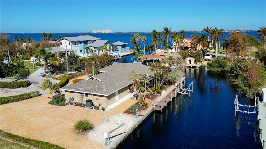 Delightful updated Pool home located on a quite cul-de-sac. Features approximately 239 Ft of water frontage just off the Caloosahatchee River. NO Bridges. Just minutes by boat to Sanibel, Back Bay or the Gulf of Mexico! Features Dock with 10 lb boat lift and davits for your smaller boat or jet skis. Meticulously maintained and upgraded. Wrap around Lanai with water views and sunset views from the Pool deck & Lanai! Large lot with room to add on or have garden space.