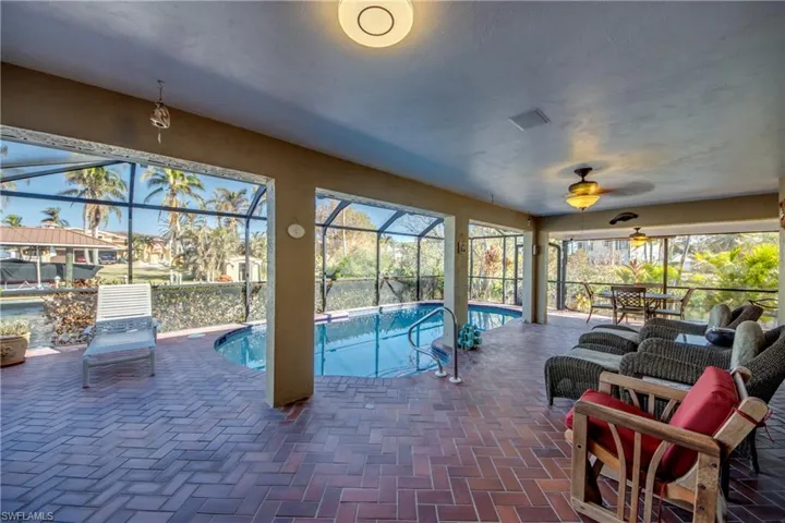 Unique wrap around Lanai offers multiple choices for covered sitting areas all with views of the waterway and access to the lovely swimming pool. All of the sliding glass doors are impact rated and pocket back allowing a fantastic flow for entertaining and allowing for the wonderful River breezes. Views from the Pool area feature River and Sunset views.