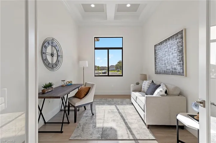 Office area featuring light hardwood / wood-style floors, coffered ceiling, beamed ceiling, and ornamental molding