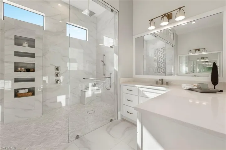 Bathroom featuring vanity and a shower with shower door