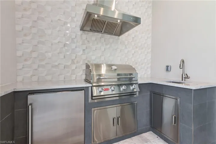 View of patio with an outdoor kitchen, area for grilling, and sink