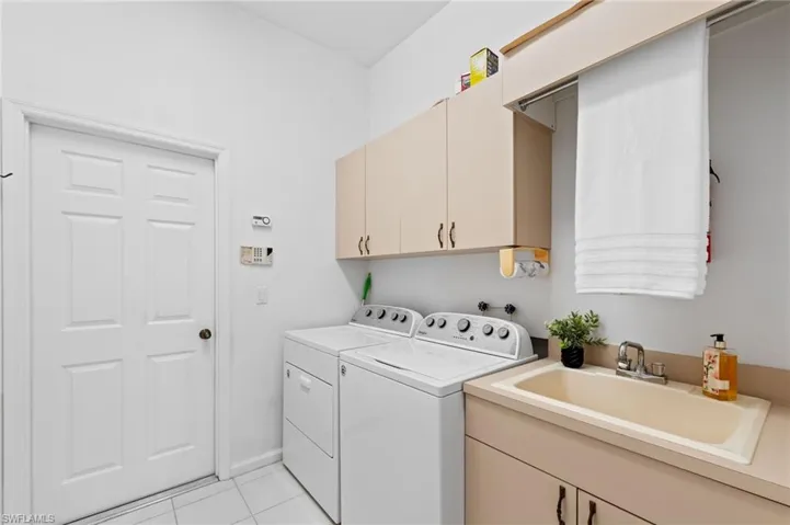 laundry with cabinets and sink