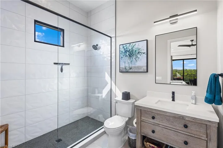 3rd Bathroom offers floor to ceiling tile, seamless glass shower enclosure. Natural light!