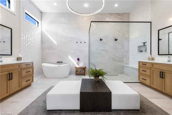 Relax in your Zen soaking tub or take a seat on the bench and enjoy the dual shower heads in your walk-in shower w/ stone pebble flooring and 5x2 ft floor to ceiling Porcelain slab tiles! Separate dual vanities w/ Quartz countertops,