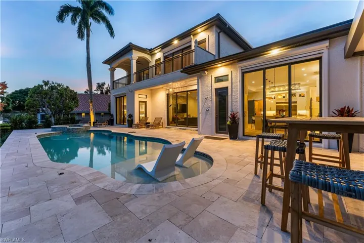 Welcome to your private Oasis! Step out onto Travertine flooring and Enjoy your open and uncovered Propane-heated pool & spa with Sun Shelf and an outdoor shower! Relax under the Cabana and enjoy entertaining Guests with the big screen TV and cozy propane gas fireplace w/ an additional under truss seating area equipped w/an outdoor kitchen! Quartz Countertop, Cabinetry w/pull out drawers, Porcelain tile backsplash, Viking Professional Grill and Zephr Hood, and Zephr Fridge.