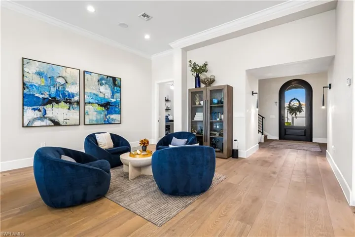 Walk through the 8ft Solid Wood Doors into the Foyer showing off its 12ft Tray Ceiling w/ recessed lighting & surround sound speakers. White Oak wide plank flooring and 7 in baseboards.
