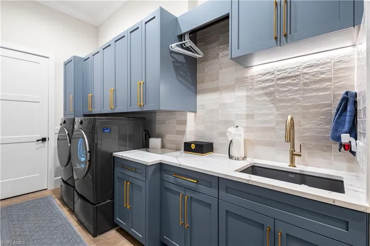 Quartz countertops, Shaker cabinets, Porcelain tile backsplash and sink. LG Washer & Dryer. Custom seating bench w/ coat hangers and upper and lower cabinetry. walk-in home electronic storage closet AND an additional walk-in Utility closet