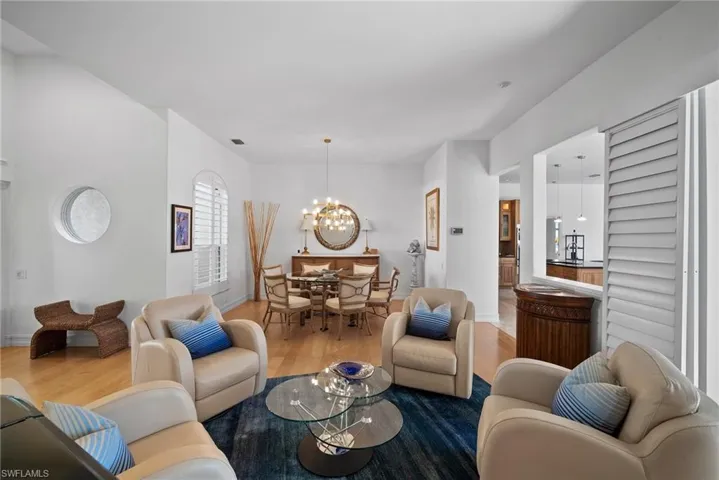 Living room with hardwood / wood-style floors and a notable chandelier