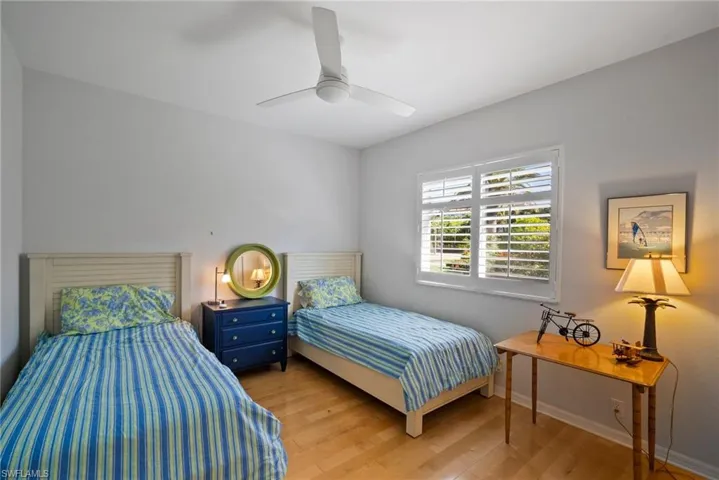 Bedroom with ceiling fan and light hardwood / wood-style floors