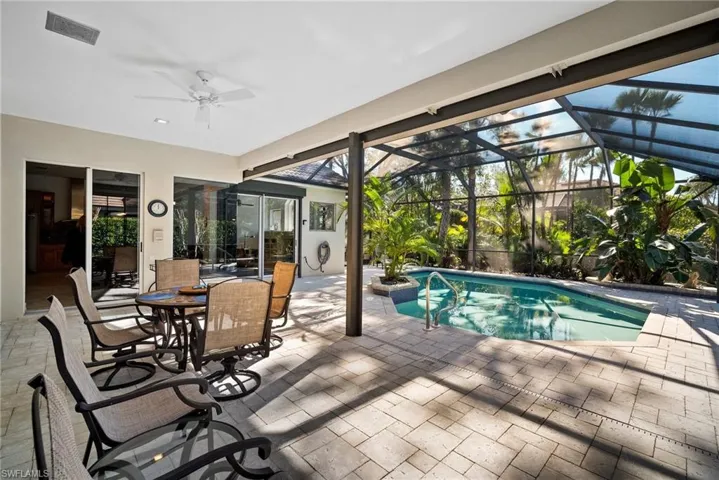 View of pool featuring a patio, ceiling fan, and a lanai