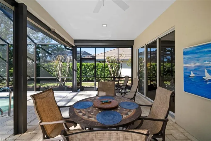 Sunroom / solarium featuring ceiling fan