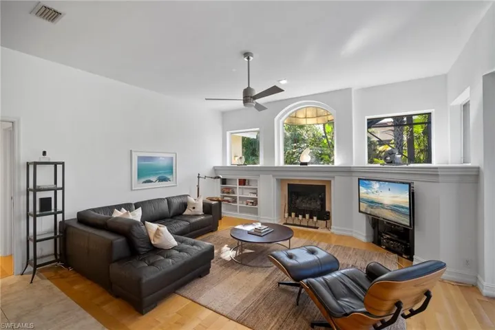 Living room with light wood-type flooring and ceiling fan