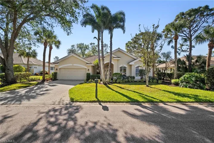 Ranch-style home with a garage and a front yard