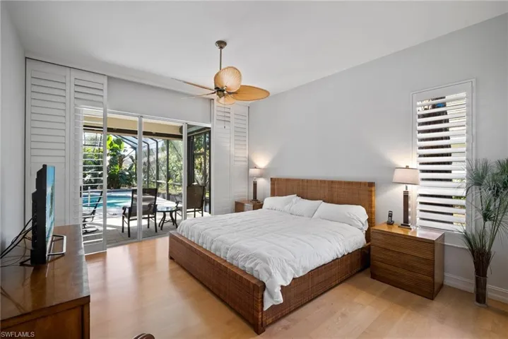 Bedroom featuring access to exterior, light hardwood / wood-style flooring, and ceiling fan