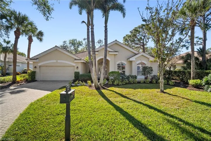 Ranch-style house featuring a front lawn and a garage