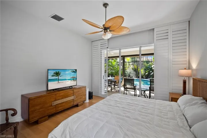 Bedroom featuring access to exterior, light wood-type flooring, and ceiling fan