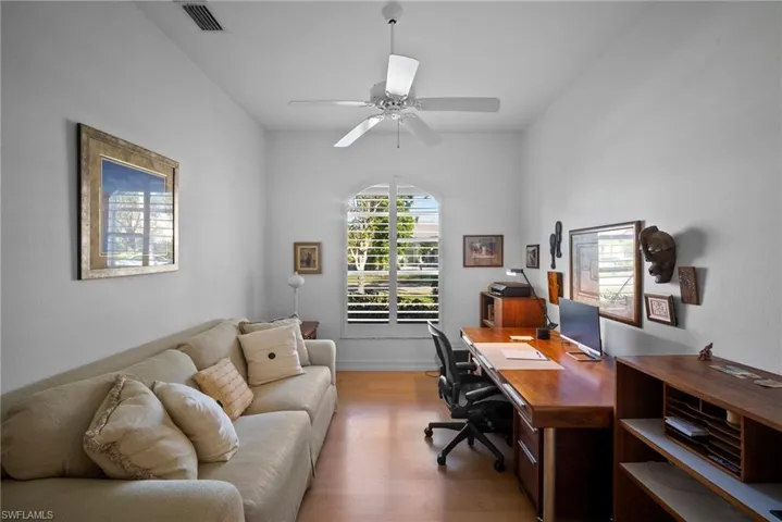 Office area with ceiling fan and light hardwood / wood-style floors