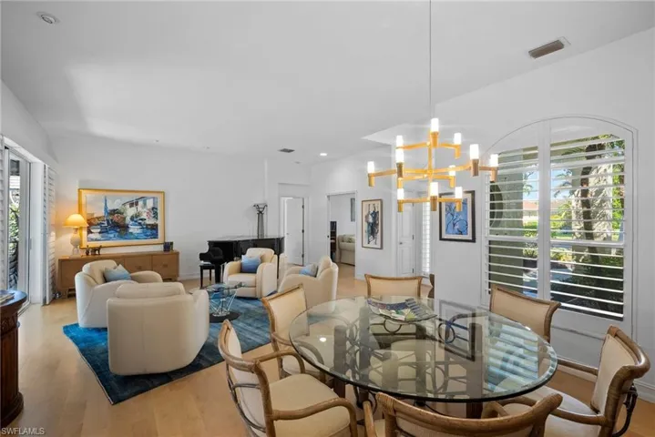 Dining room with a chandelier, a wealth of natural light, and light hardwood / wood-style floors