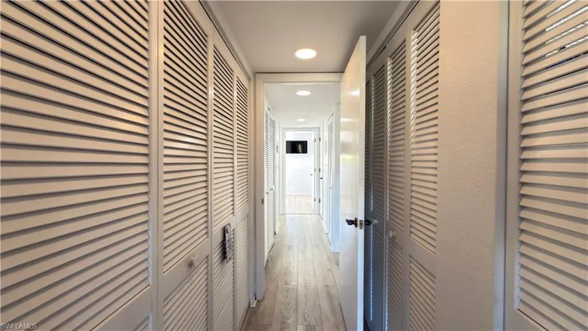 Hall featuring recessed lighting and wood finished floors