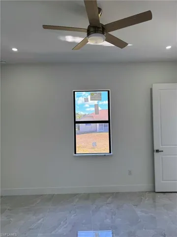 Empty room with recessed lighting and ceiling fan