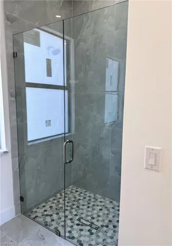 Bathroom featuring a marble finish shower
