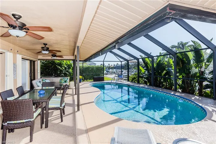Pool featuring a patio, a lanai, and a ceiling fan