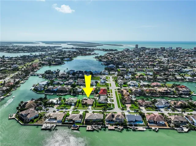 Birds eye view of property with a water view
