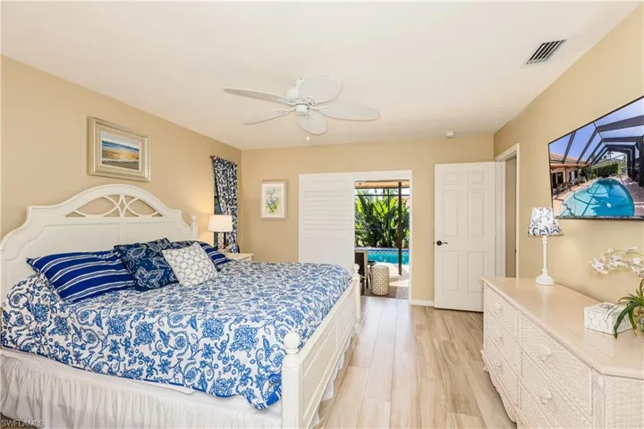 Bedroom with baseboards, visible vents, a ceiling fan, access to outside, and light wood-type flooring