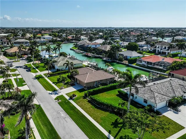 Birds eye view of property featuring a water view and a residential view