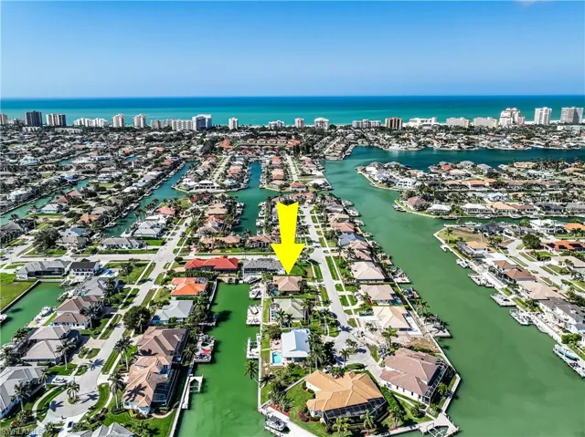 Birds eye view of property with a water view