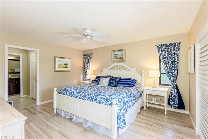 Bedroom featuring light wood-type flooring, ceiling fan, and baseboards