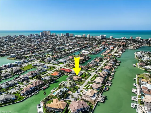 Birds eye view of property with a water view