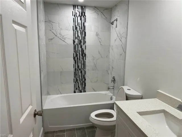 Full bath featuring bathtub / shower combination and vanity