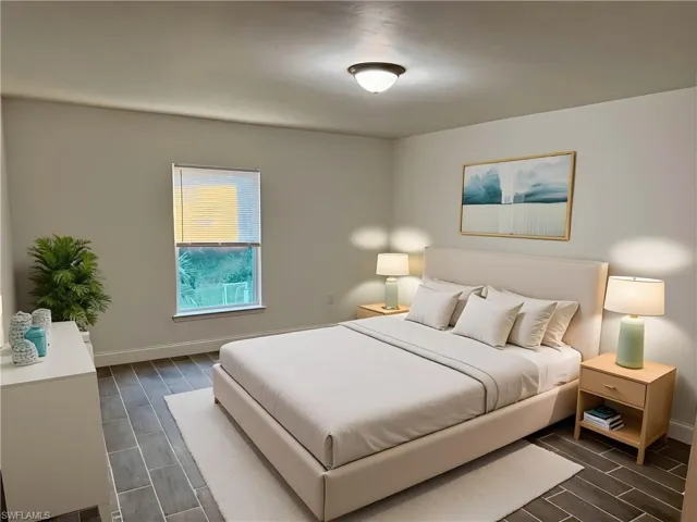 Bedroom with wood tiled floors