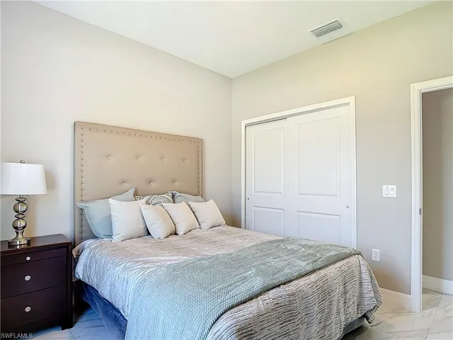 Tiled bedroom with a closet