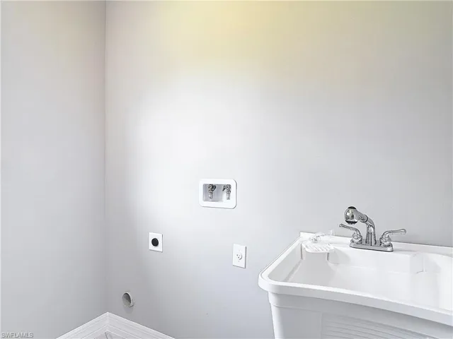 Washroom featuring sink, washer hookup, and hookup for an electric dryer