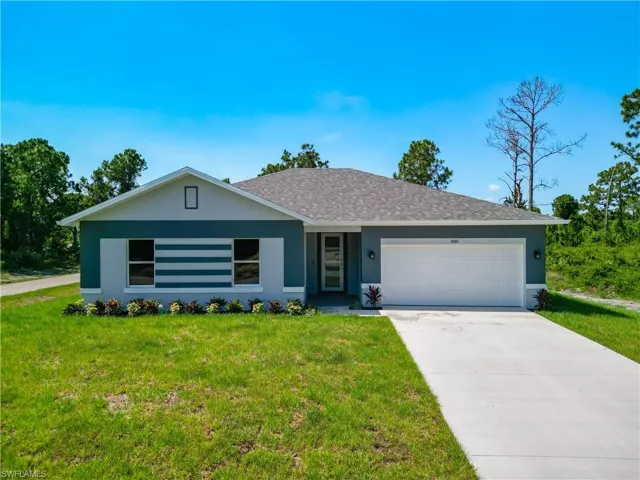 Ranch-style house featuring a garage and a front yard